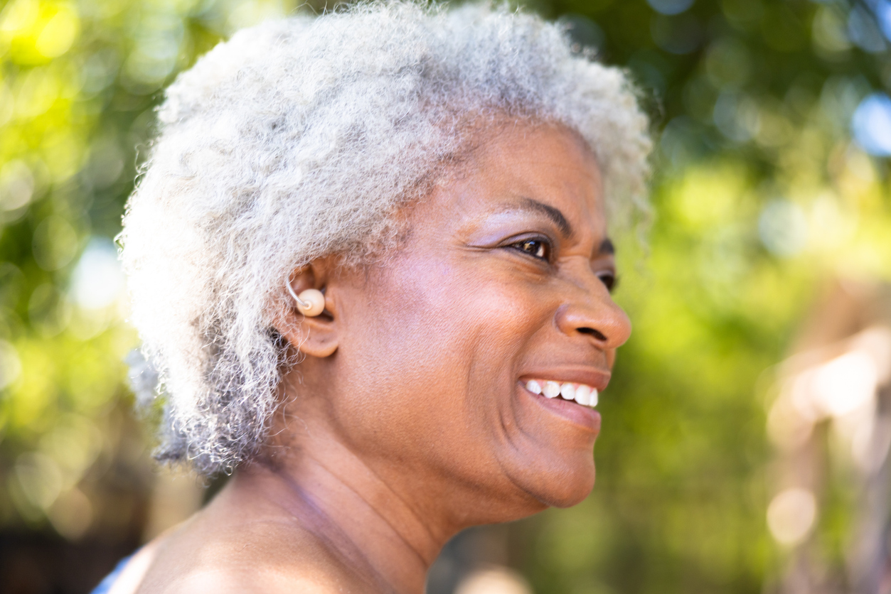 Woman with hearing aid smiles