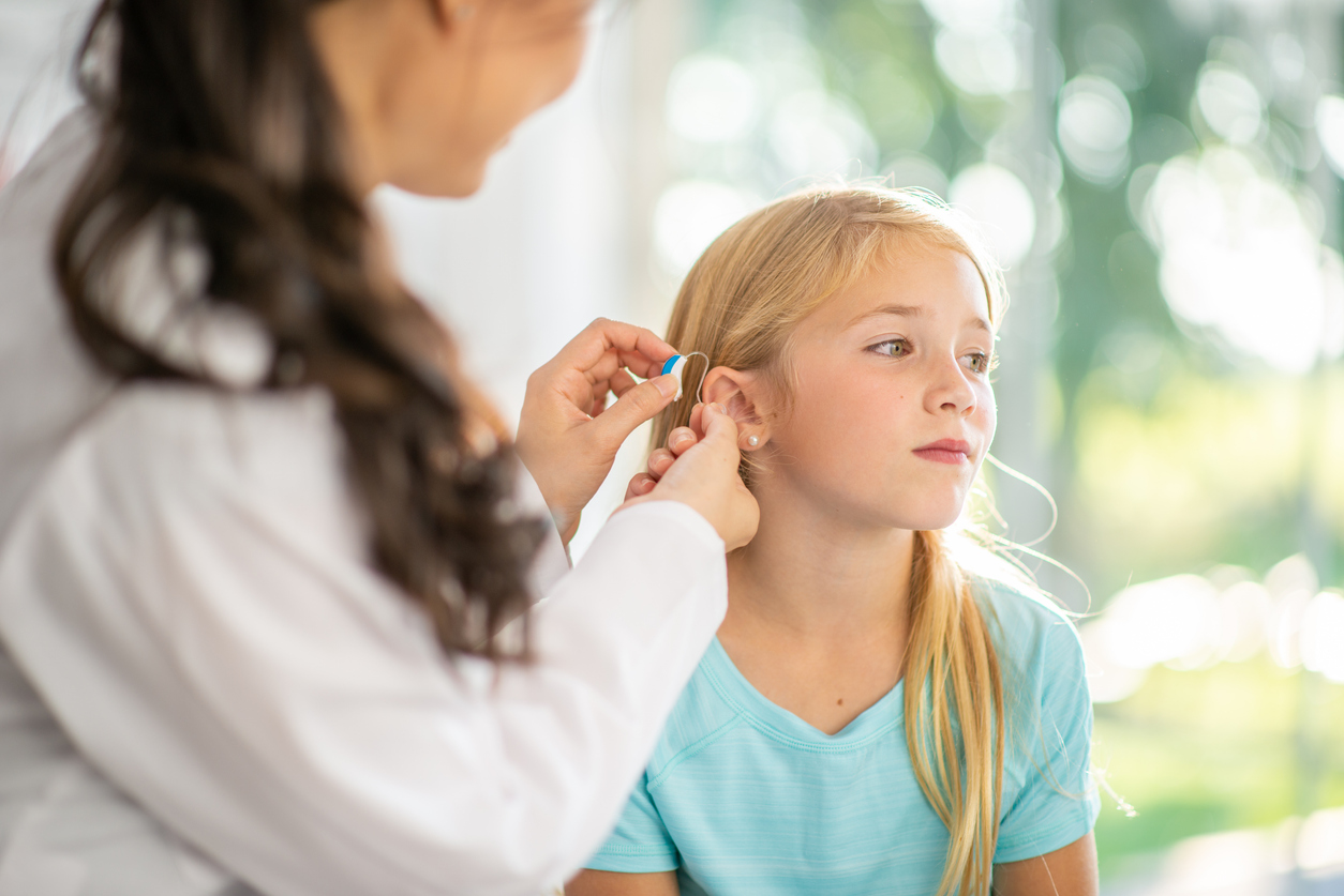 Young girl gets fitted for hearing aid