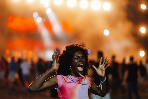 Excited woman enjoying a dynamic concert