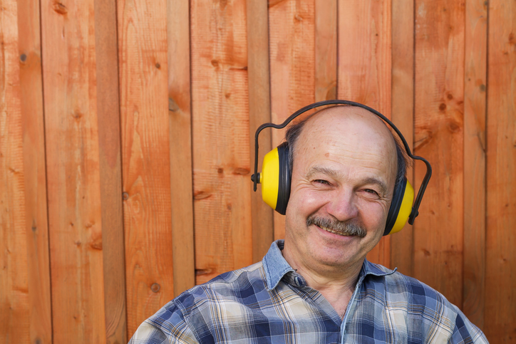 oldery man in a protective building headphones